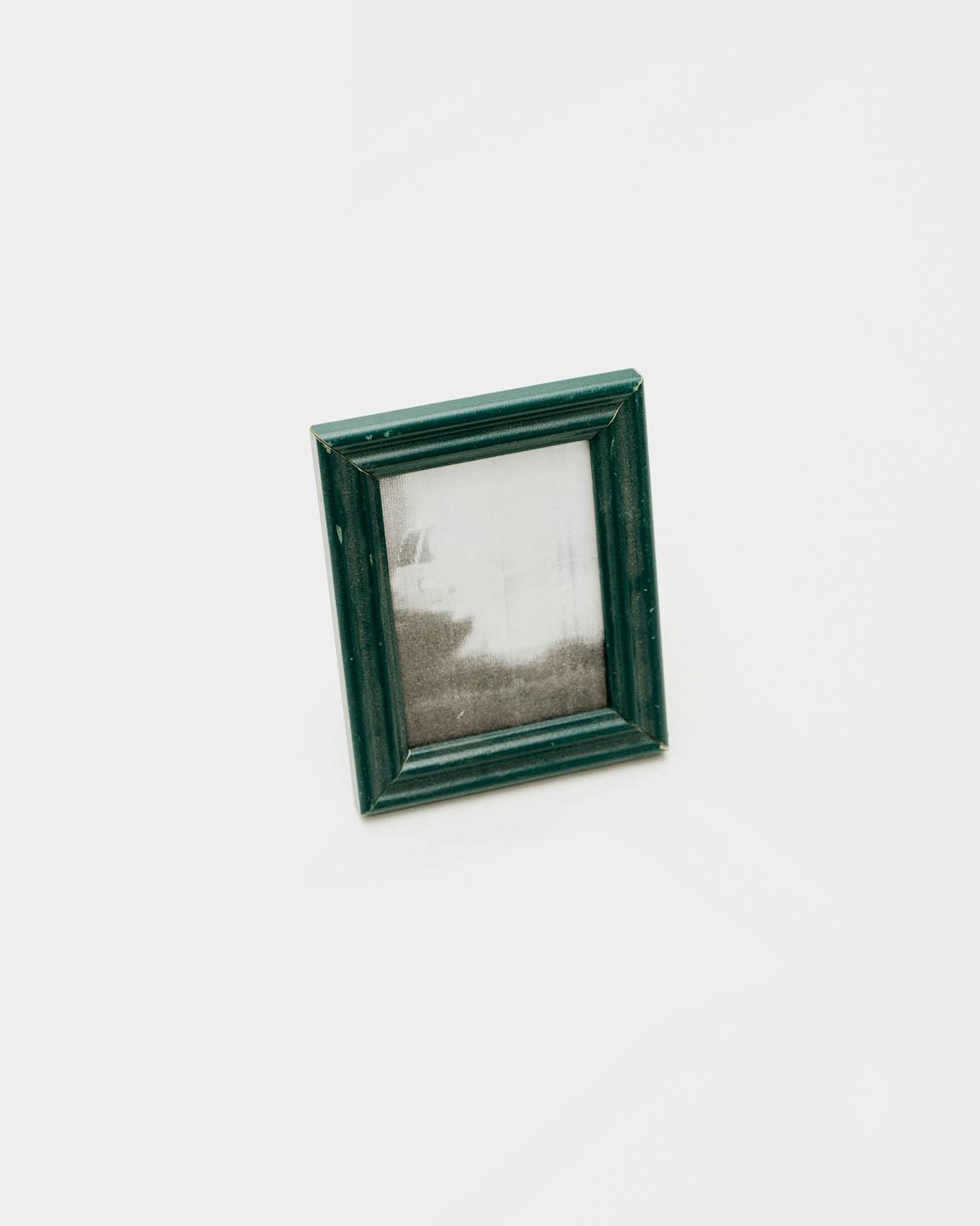 A small photo with a green frame.